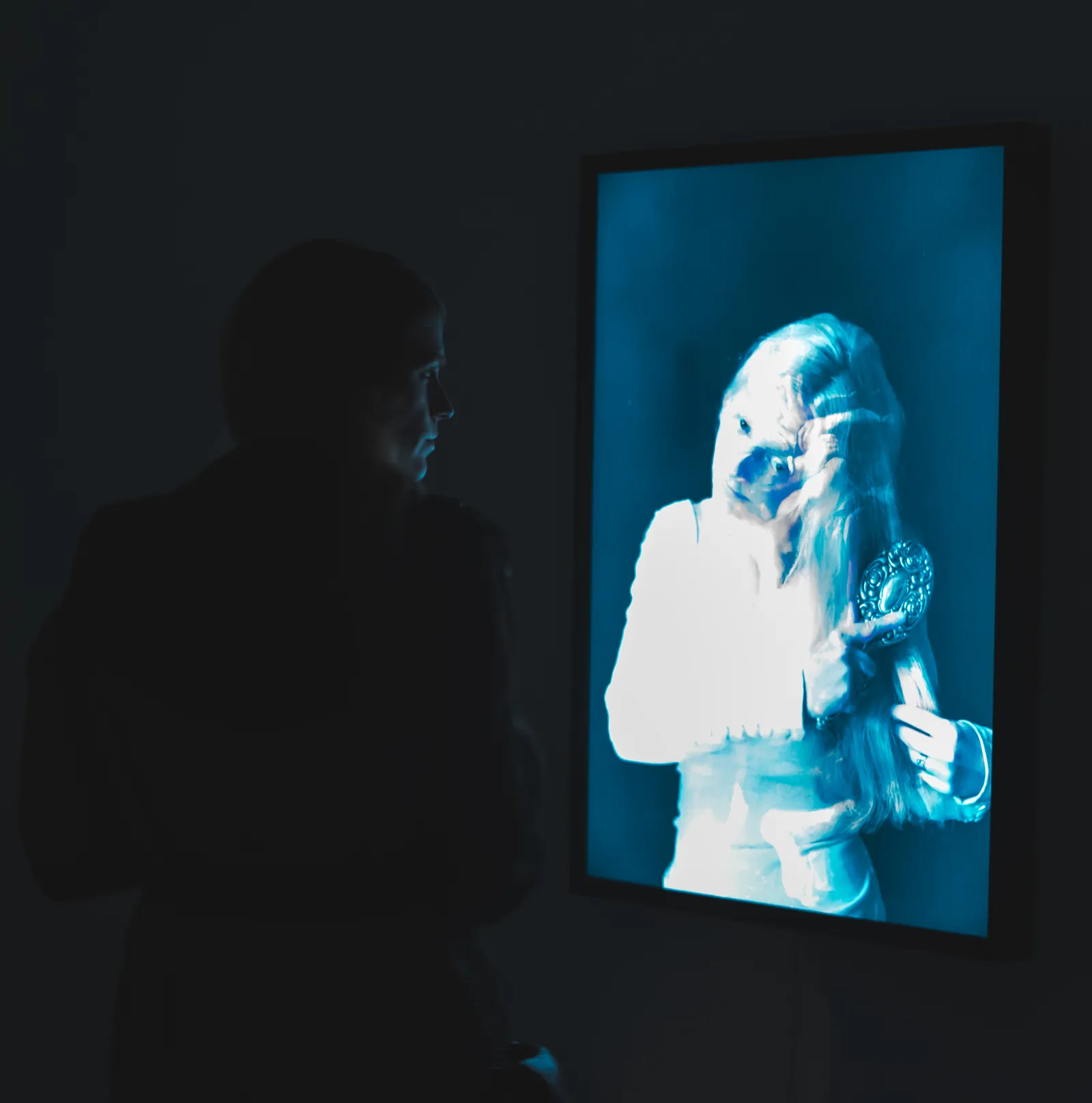 A visitor viewing work at Fairhurst Gallery